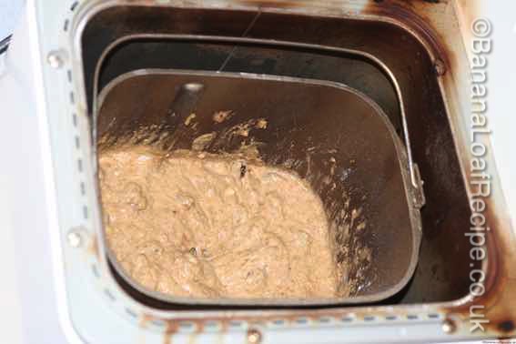 banana loaf mixture in bread maker bucket